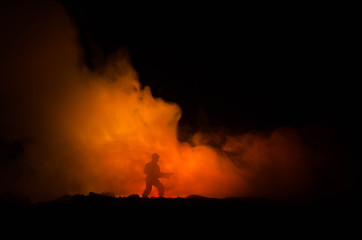 War Concept. Military silhouettes fighting scene on war fog sky background, World War Soldiers Silhouettes Below Cloudy Skyline At night. Attack scene. Armored vehicles. Tanks battle