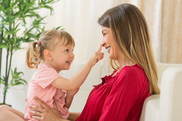 happy mother and daughter at home