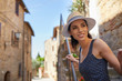 © ZoomTeam - attractive woman tourist with hat in old italian town