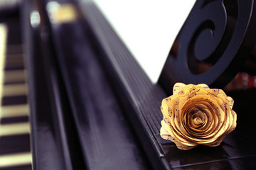 Poster - Rose made of music notes on black piano