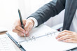 © topntp - Close-up hand of businessman writing