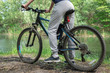 © Алексей Еремеев - Relax on a mountain bike ride along the forest path. Sports and the concept of active life in the summer. Horizontal frame
