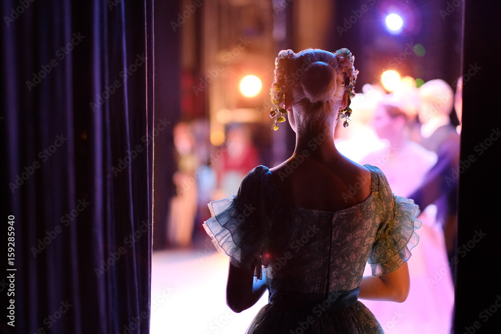 A ballerina awaiting the moment of entering the stage in the play - obrazy, fototapety, plakaty 