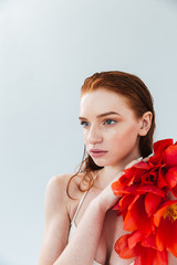 Sticker - Close up portrait of a redheaded woman holding tulip flowers