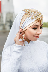 Wall Mural - Happy islamic bride in white oriental hijab scarf and muslim jewelry decorations during nikah wedding ceremony