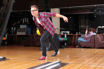 Poster - Young man having fun and playing bowling