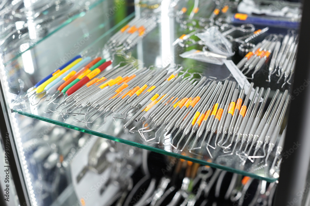 Set of professional dental explorers on glass shelf