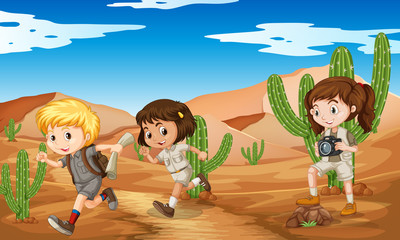 Wall Mural - Three kids in safari outfit running in desert