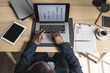 © LUMINA IMAGES - Overhead view of businessman working on laptop in office