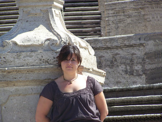 Beautiful young woman with a romantic look at the Spanish steps in Rome