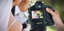 Composite Image Of Cropped Hand Of Photographer Holding Camera 
