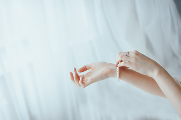 the bride wears a bracelet on hand