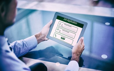 Poster - Composite image of businessman using his tablet 