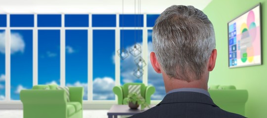 Poster - Composite image of rear view of businessman