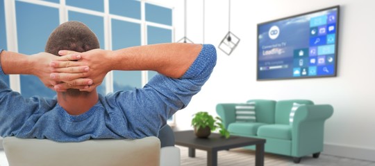 Poster - Composite image of rear view of busnessman relaxing on chair