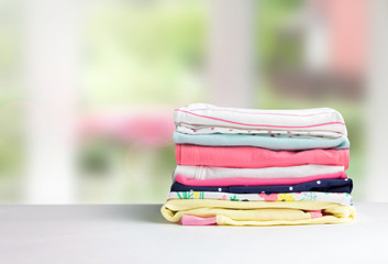 Wall Mural - Stack cotton clothes on table empty space background.