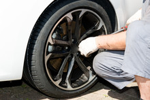 Man Technician Comes To Repair A Punctured Wheel