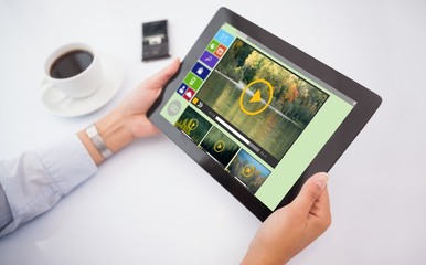 Poster - Composite image of man using tablet pc