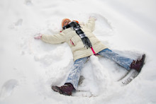 Young Girl Making A Snow Angel