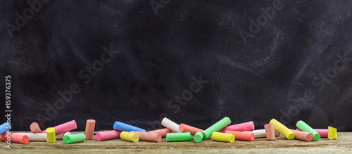 Cuadros en Lienzo Colorful chalks and a blackboard
