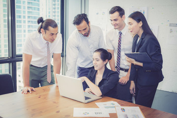 Wall Mural - Business team having a meeting using laptop during a meeting and presents.