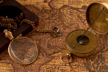 Old vintage retro compass on ancient world map. Vintage still life. Travel geography navigation concept background.