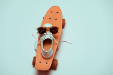 High Angle View Of Hipster Penny Board, One Sneaker And Sunglasses Making Smiley Composition