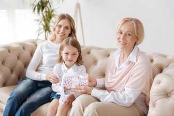 Wall Mural - Loving grandmother congratulating her granddaughter