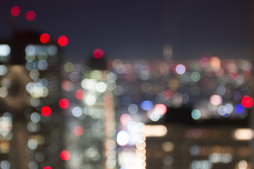 colorful blur bokeh of the shinjuku at night, view through glass from metropolitan government buildi
