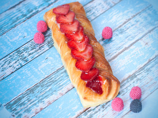 Wall Mural - Dessert with strawberries and berry candies on a wooden board