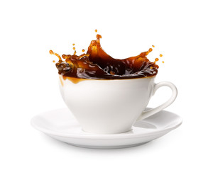 Wall Mural - Coffee splashing out of a cup isolated on white background.