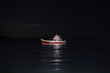 A boat on the sea at night