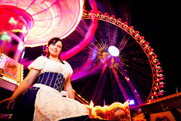 Young Woman Sitting Next To Carousel