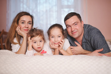 Wall Mural - young family lying in bed at home