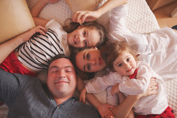 Wall Mural - young family lying in bed at home