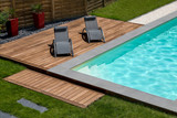 Fototapeta  - piscine terrasse en bois exotique et transat