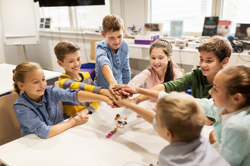 Wall Mural - happy children holding hands at robotics school