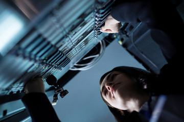 Nice pleasant woman standing near the network server