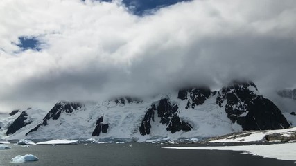 Wall Mural - Time lapse clouds over mountains in Antarctica. 