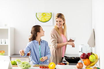 Poster - happy family cooking salad at home kitchen