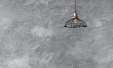 Industrial Pendant Lamps Against Rough Wall With Gray Cement Plaster.