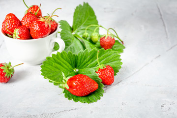 Wall Mural - Fresh strawberries in a white porcelain bowl on wooden table in rustic style