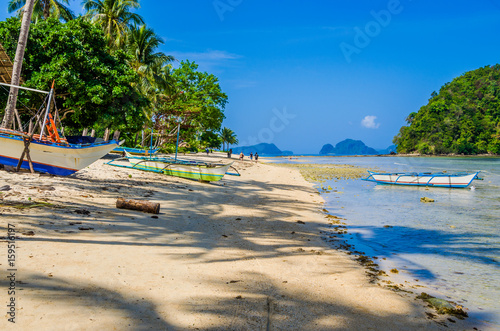 Fishing Boats On Shore Under Palms Tropical Island Landscape El Nido Palawan Fishing Boats On Shore Under Palms Tropical Island Landscape El Nido Palawan