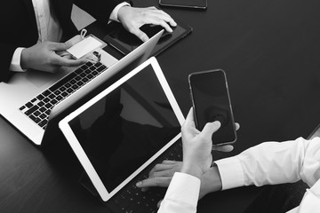 co working team meeting concept,businessman using smart phone and digital tablet and laptop computer and name tag in modern office