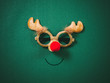 © everythingpossible - Christmas glasses that decoration with Christmas reindeer and red ball on green background