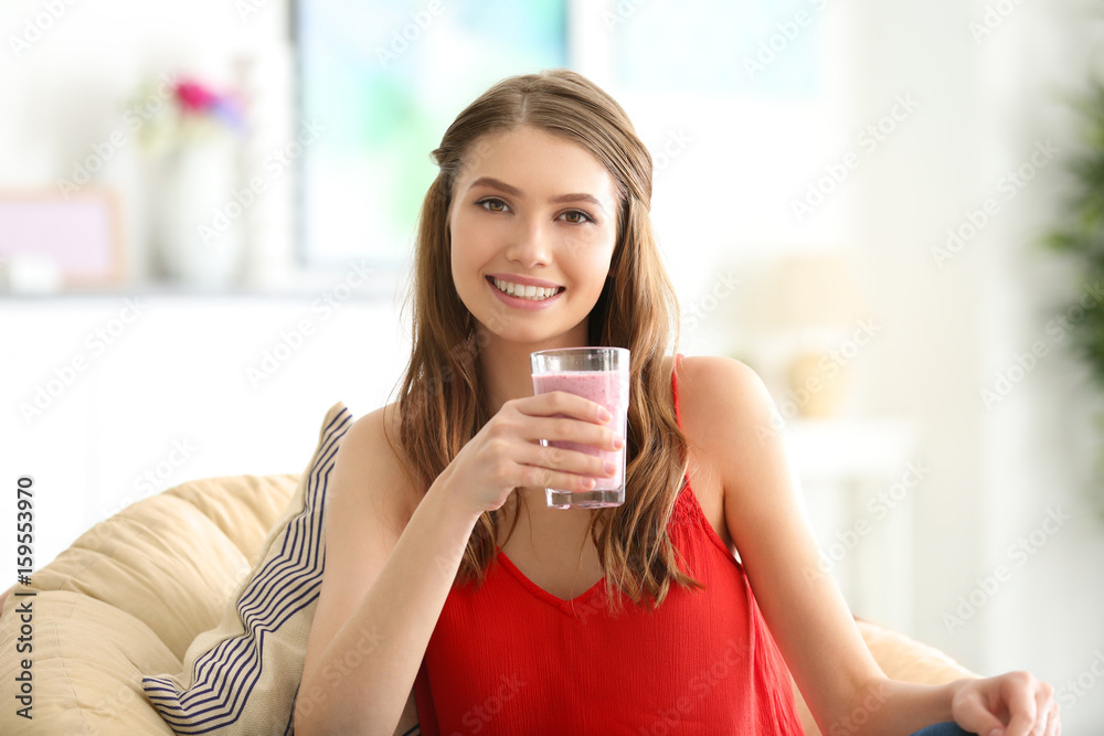 Weight loss concept. Beautiful young woman drinking healthy delicious smoothie at home