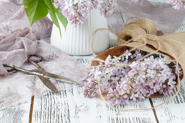 Wall Mural - Beautiful lilac flowers on pink cloth background