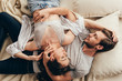 High angle view of beautiful young couple in love hugging while lying on bed
