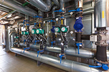 Wall Mural - The interior of a modern gas boiler house with pumps, valves, a multitude of sensors and barrels