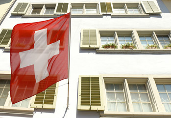 Canvas Print - Swiss Flag on the facade building in Zurich, Switzerland